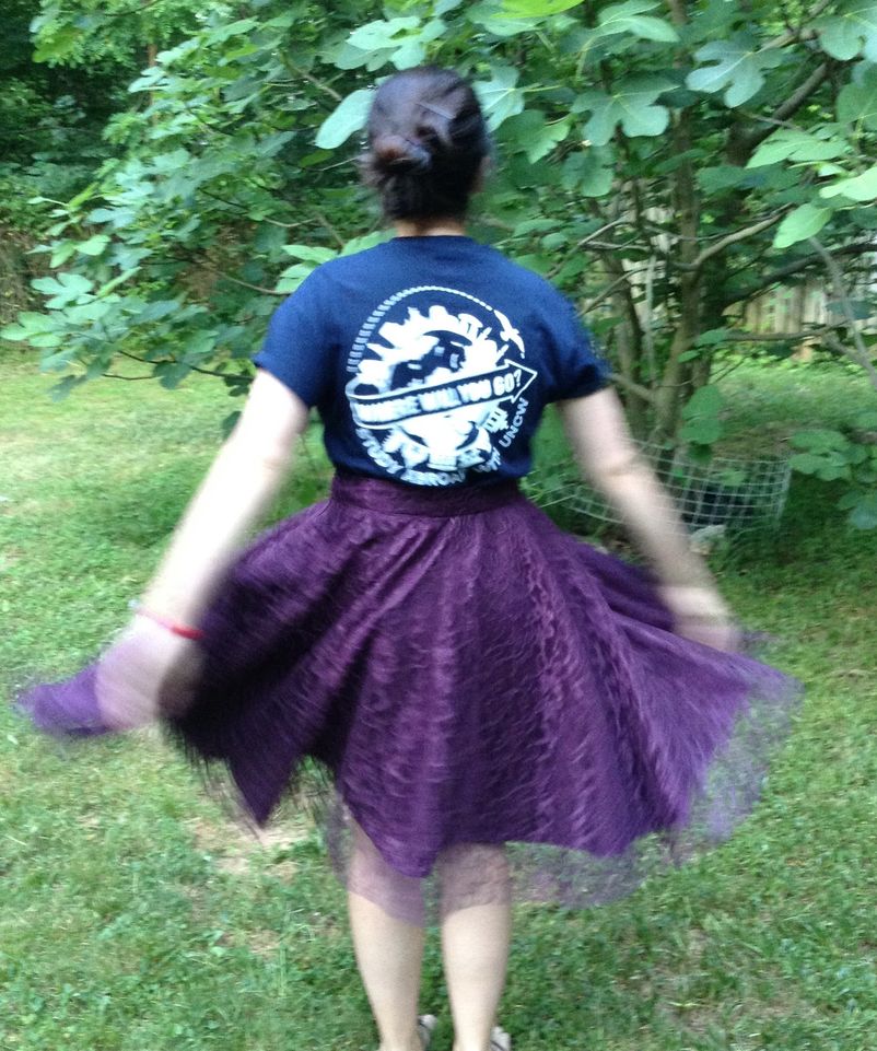 A full purple skirt swishing